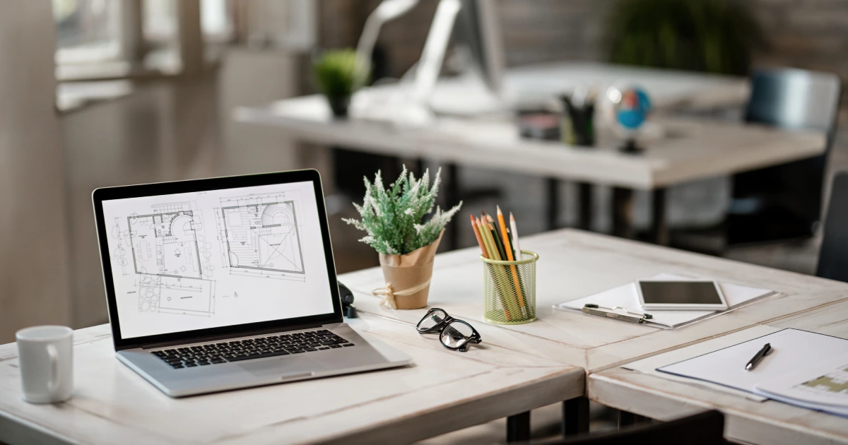 Modern architecture workspace with laptop and blueprints reflecting professional website design